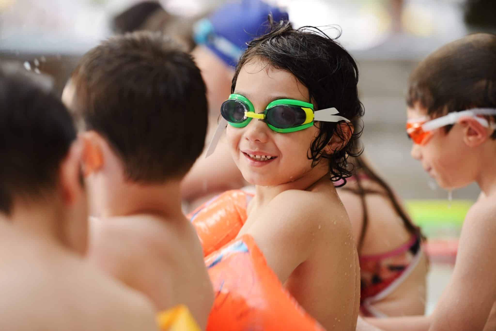Kids enjoying swimming and fun at a custom pool by O'Neil Pools, LLC.